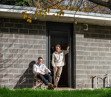 Two Yeowarra team members at onsite accommodation. One is sitting, and the other is standing.